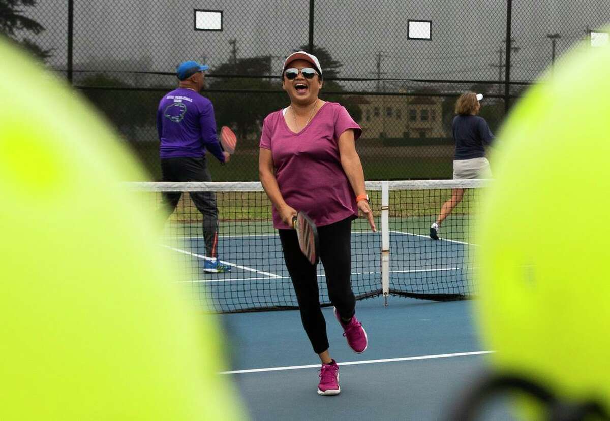 Shelly Thomas cheers after scoring a point while playing pickleball at the courts near Louis Sutter Playground in McLaren Park.
