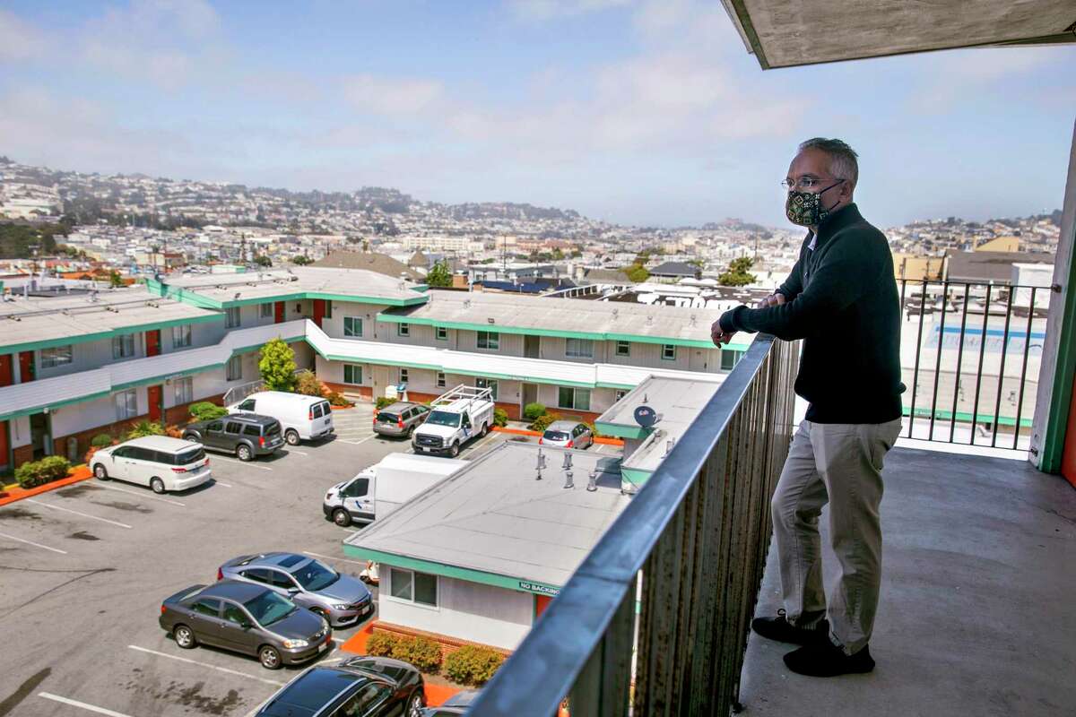 Amit Motawala, then owner of the Mission Inn, looks out over his Outer Mission hotel in August 2021. The city of San Francisco has bought the building as housing for people who were formerly homeless.