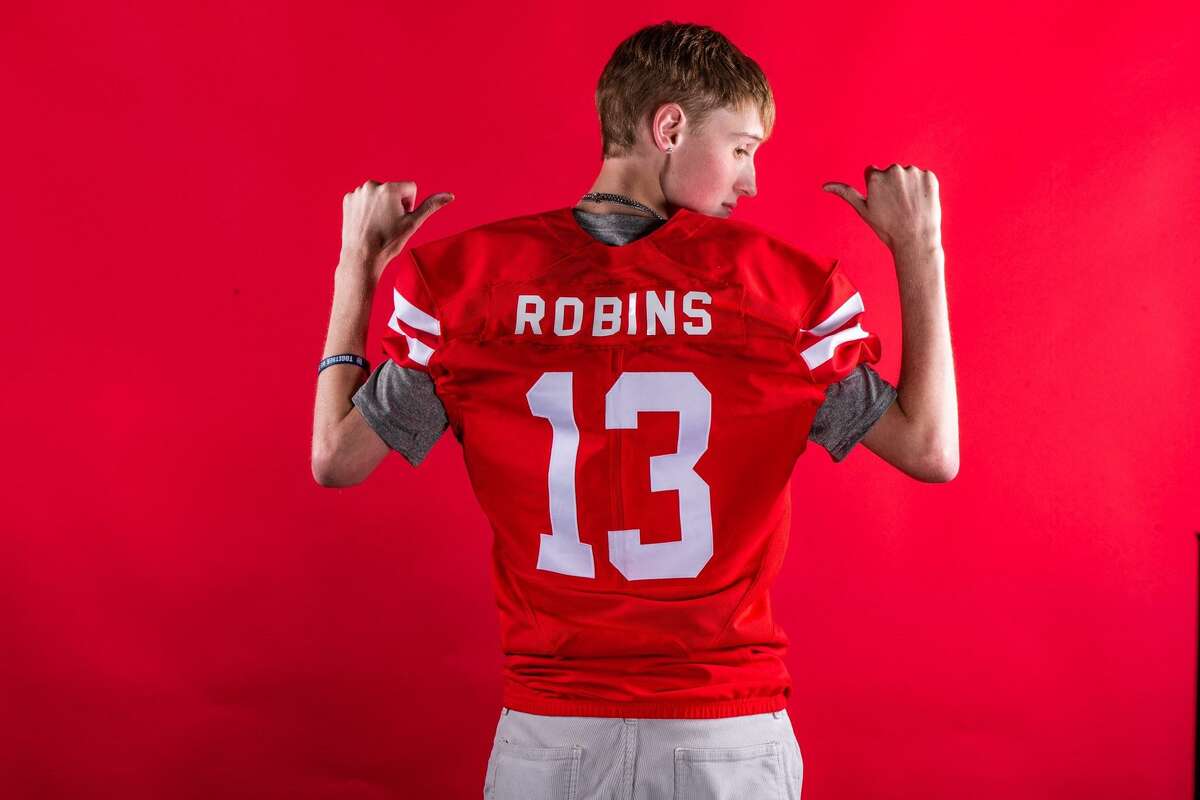 Vinny Robins, a senior at Barbers Hill, shows off the jersey presented to him by the University of Houston football team, with whom he connected via Team IMPACT, which pairs college sports programs with chronically ill children. Robins passed away Aug. 10 at age 17.