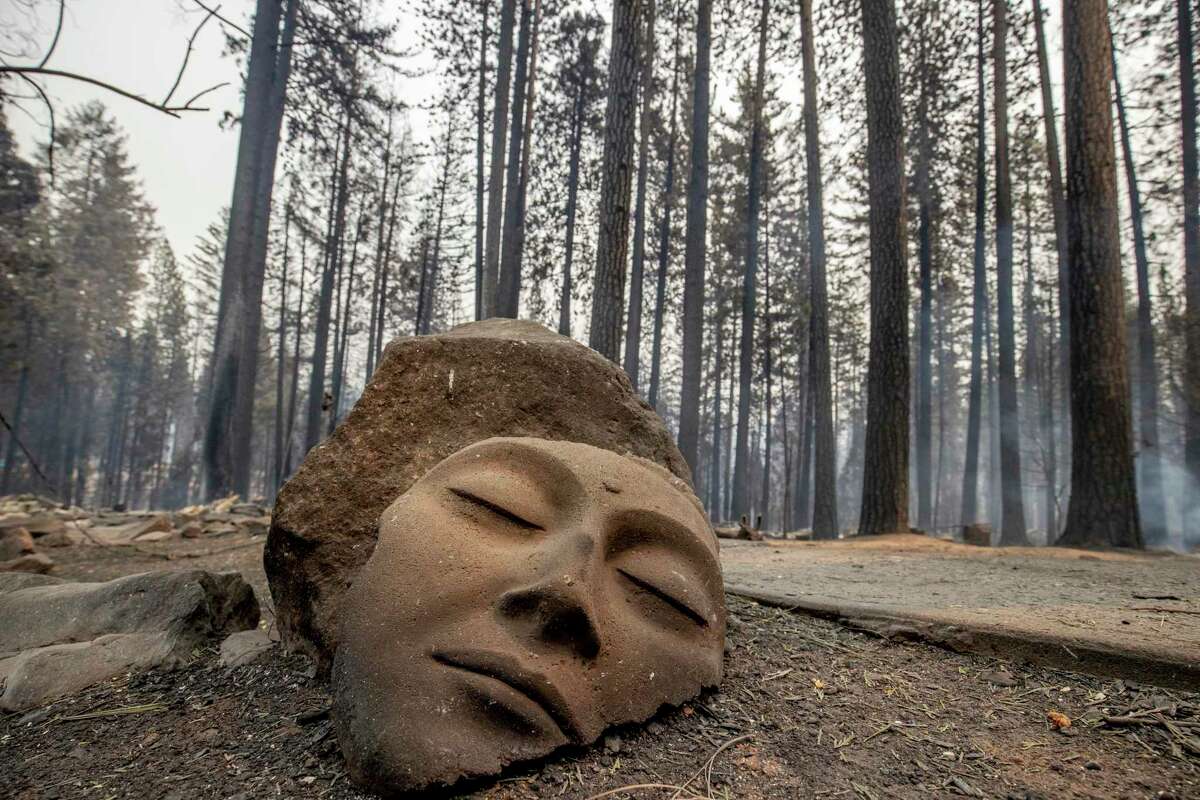 A sculpture rests in front of a Grizzly Flats home destroyed by the Caldor Fire in El Dorado County, Calif.