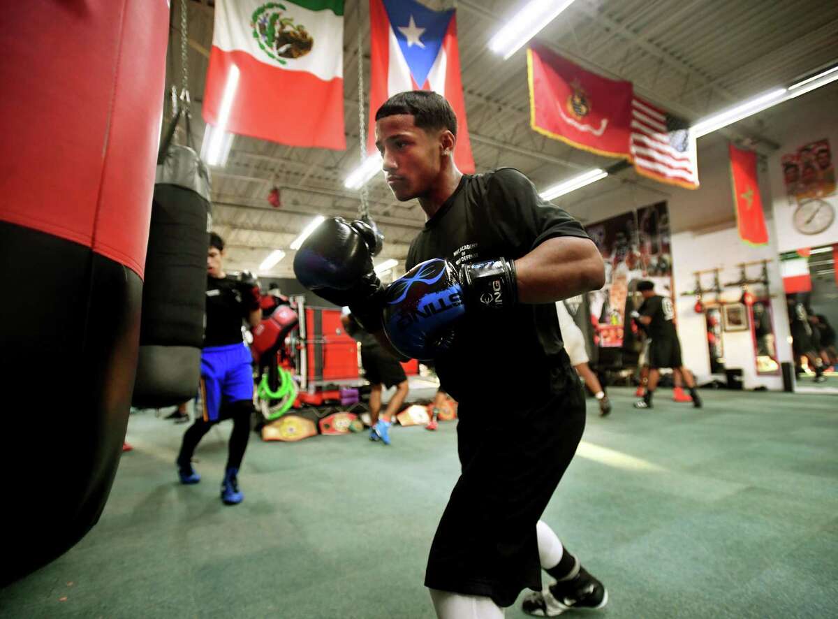 Joseph Chisholm, 15, of Stratford, hits the heavy bag along with his fellow boxers at the Chick Rosnick Boxing Club in Stratford, Conn. on Monday, August 16, 2021.