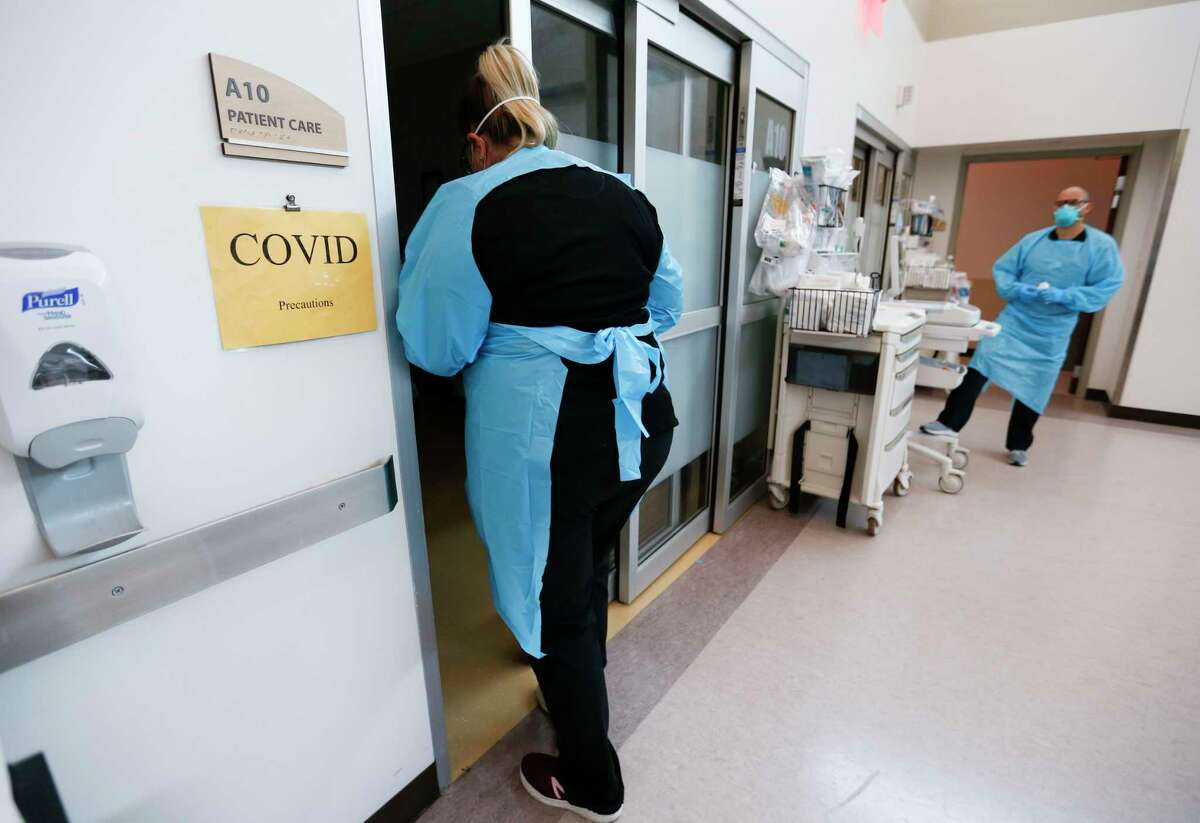 FILE - In this July 16, 2021, file photo, nurses and doctors in the CoxHealth Emergency Department in Springfield, Mo., don personal protective equipment to treat patients with COVID-19. Many overwhelmed hospitals, with no beds to offer, are putting critically ill COVID-19 patients on planes, helicopters and ambulances and sending them hundreds of miles to far-flung states for treatment. (Nathan Papes/The Springfield News-Leader via AP, File)