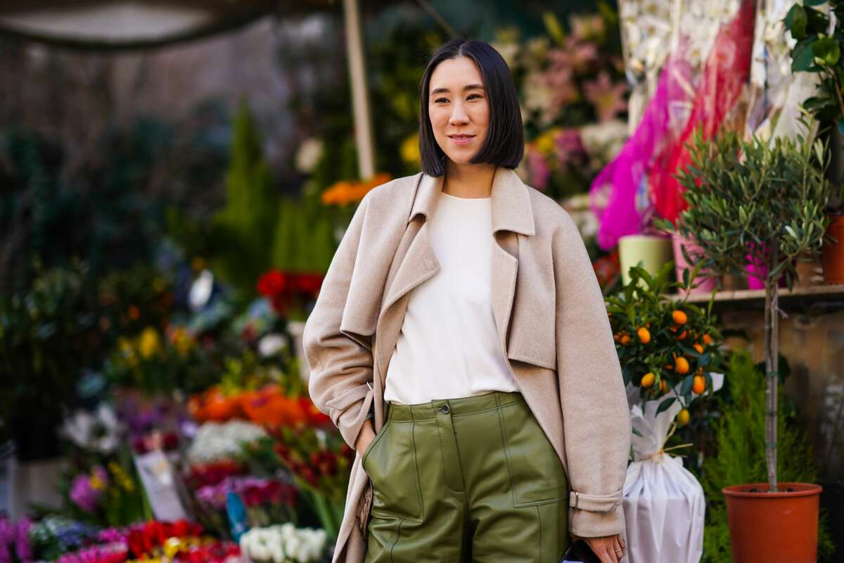 Eva Chen wears a beige long coat, a white t-shirt, green leather pants, pointy shoes, outside Koche x Pucci, during Milan Fashion Week Fall/Winter 2020-2021 on February 20, 2020 in Milan, Italy. (Photo by Edward Berthelot/Getty Images)