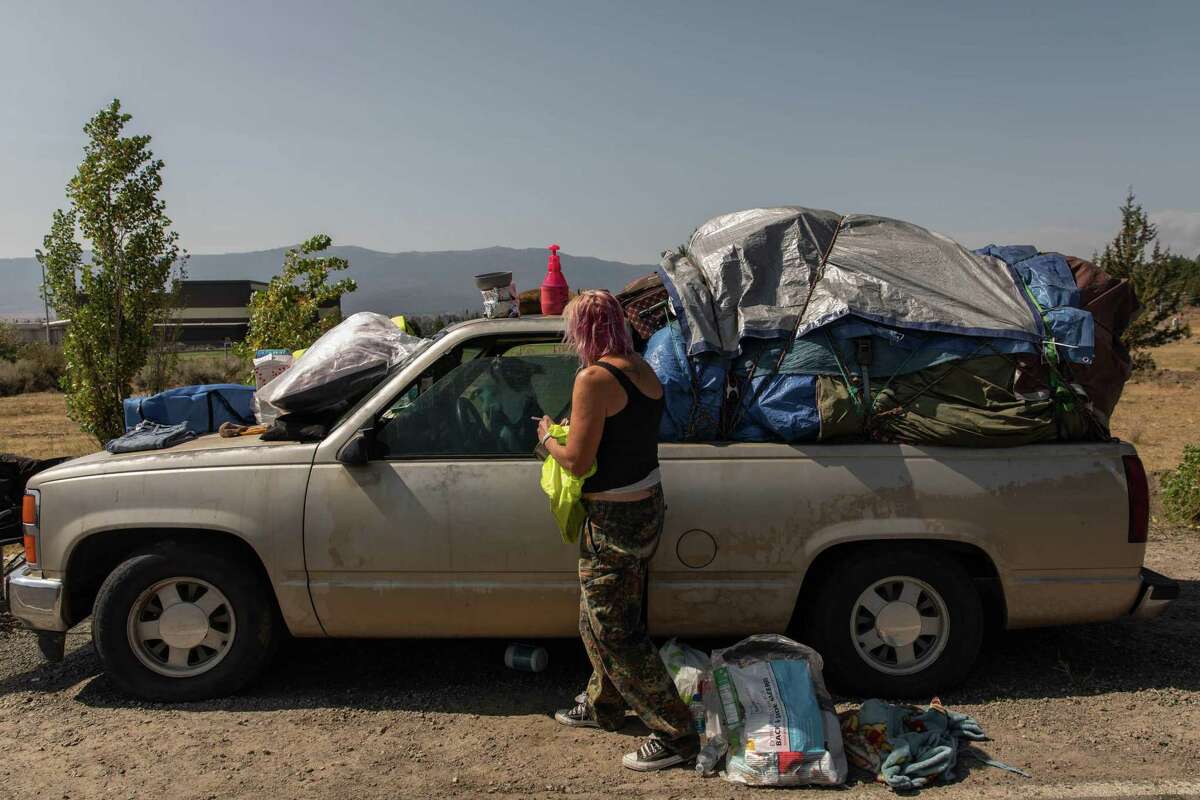 Regina Rutledge packs up her truck Wednesday as she and others prepare to return to the town of Chester after staying several weeks at an evacuation shelter in Susanville after fleeing Dixie Fire.
