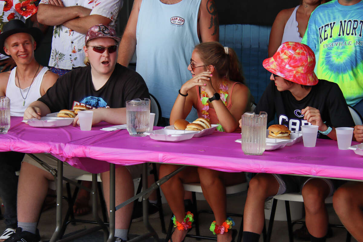 More than one dozen people compete for bragging rights in the cheeseburger eating contest Aug. 18, 2021.