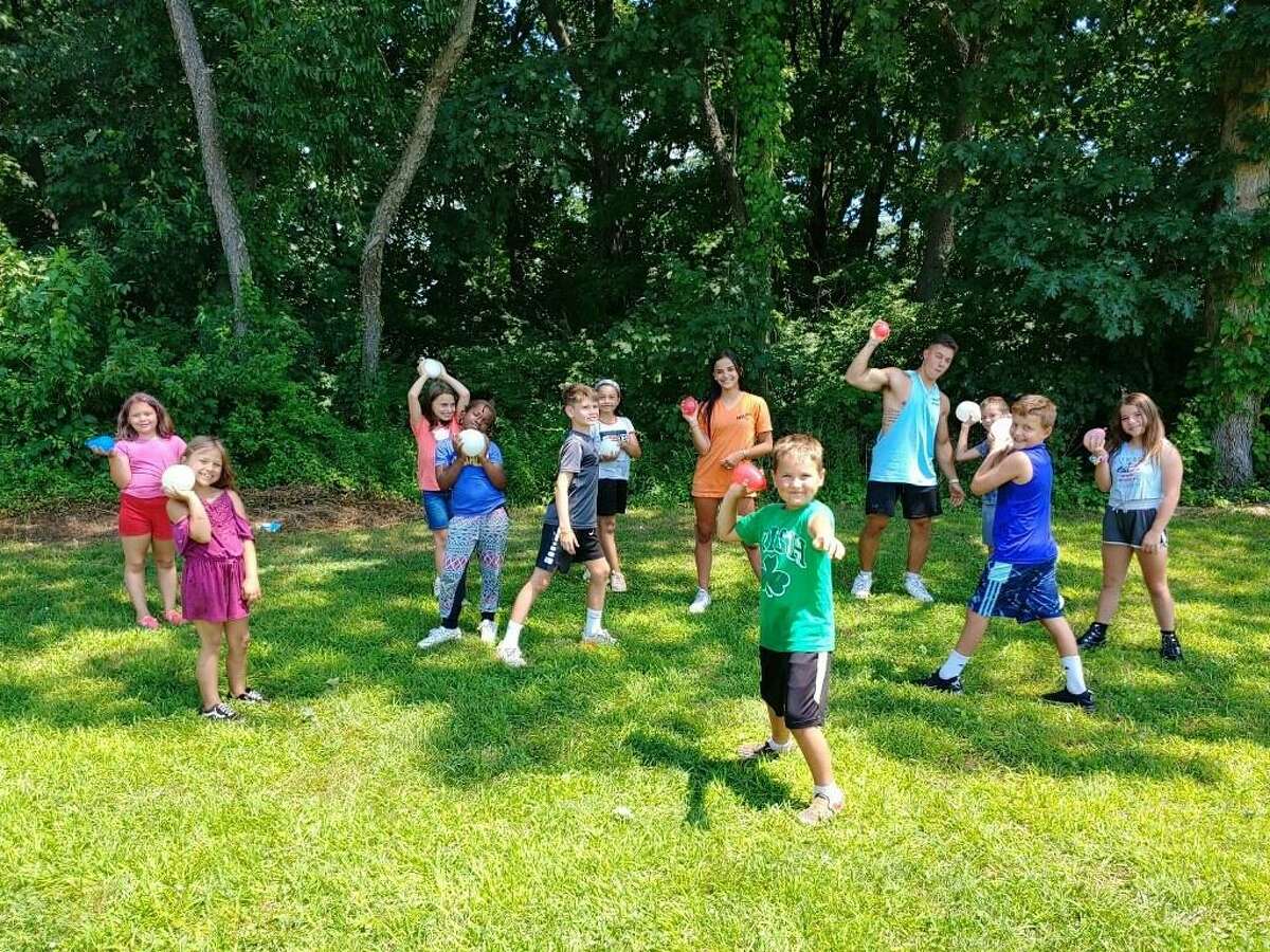 Sunnyside campers get ready for a water balloon toss at the annual party on the last day of the summer playgrounds party. Counselors Josh Mauriello and Jenna Fette take aim.