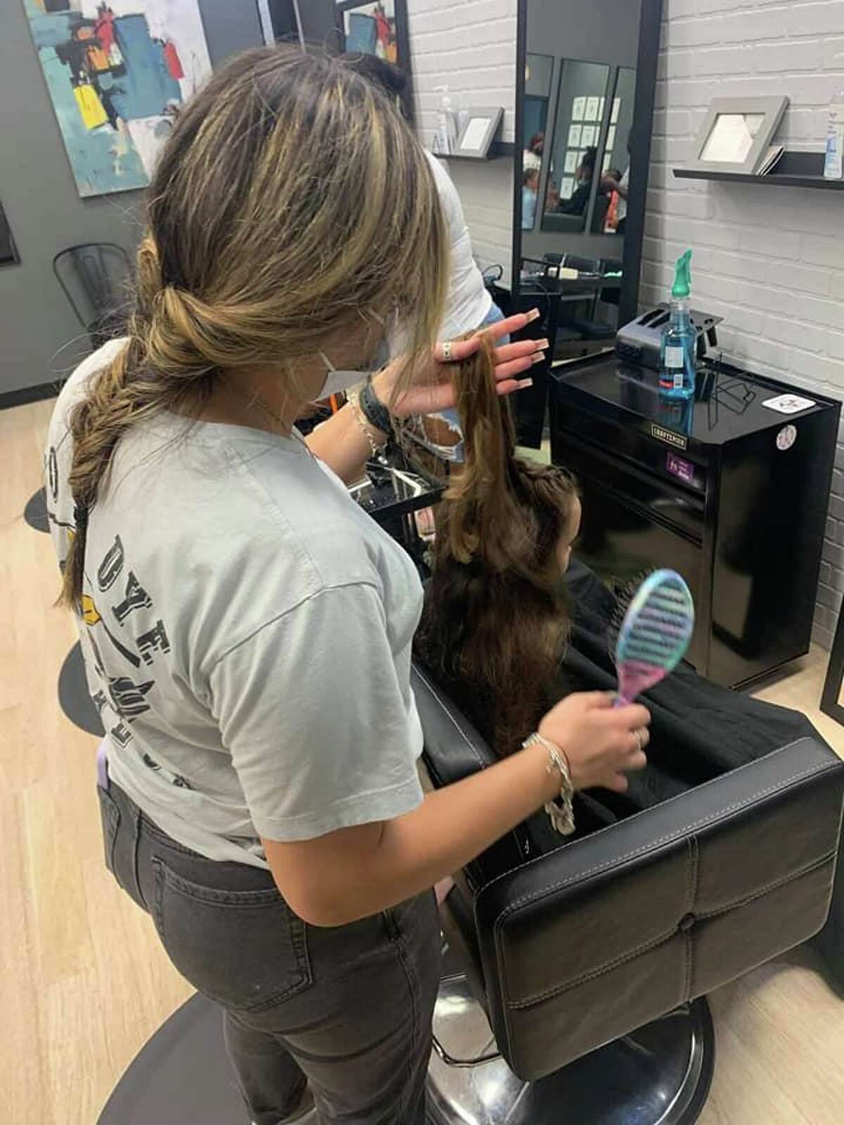 Dozens of fades, tapers, braids and trims for boys and girls were performed by the staff, including Kane’s wife, Olivia who owns the adjoining salon and spa, Do or Dye.