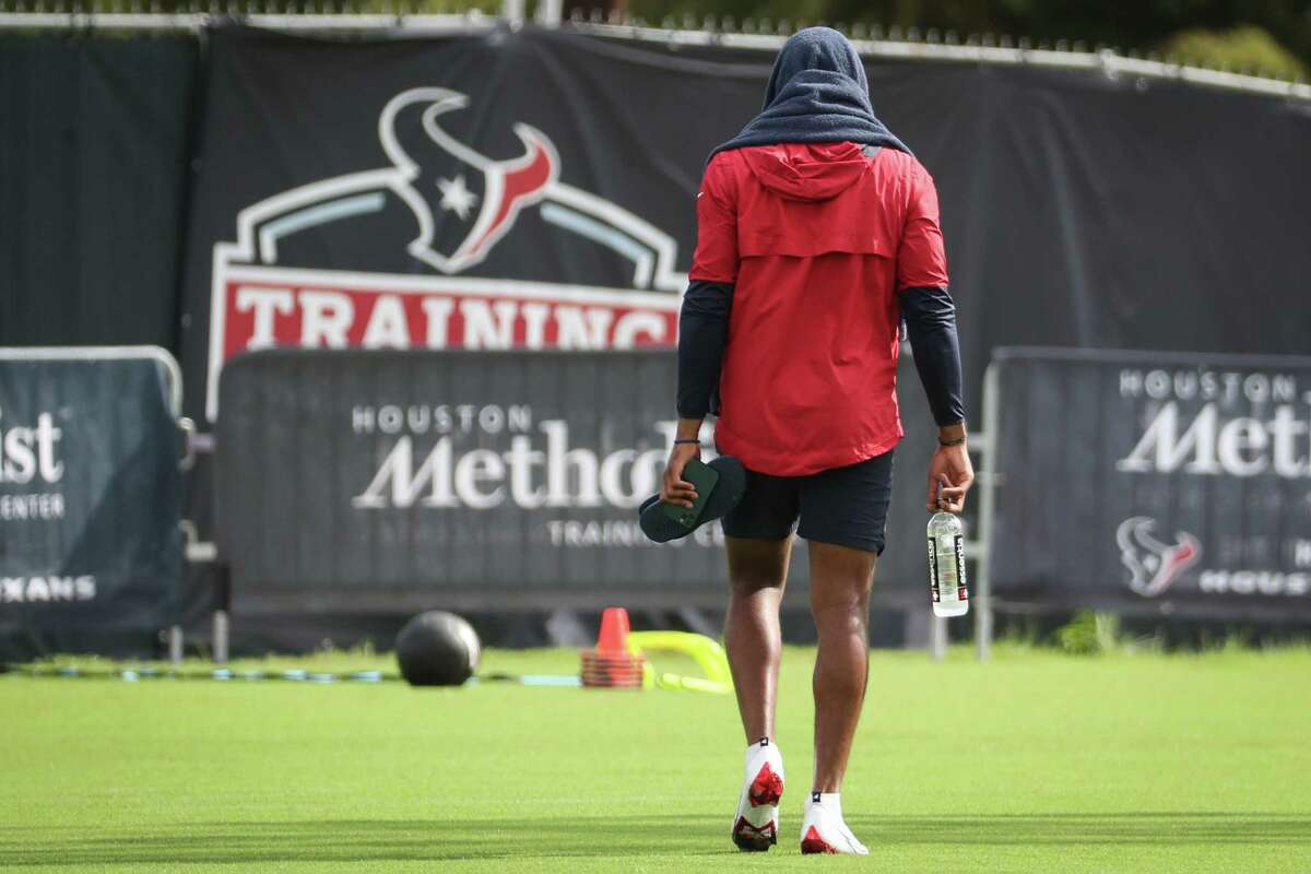Houston Texans quarterback Deshaun Watson walks across the field to work out on the side during an NFL training camp football practice Thursday, Aug. 19, 2021, in Houston.