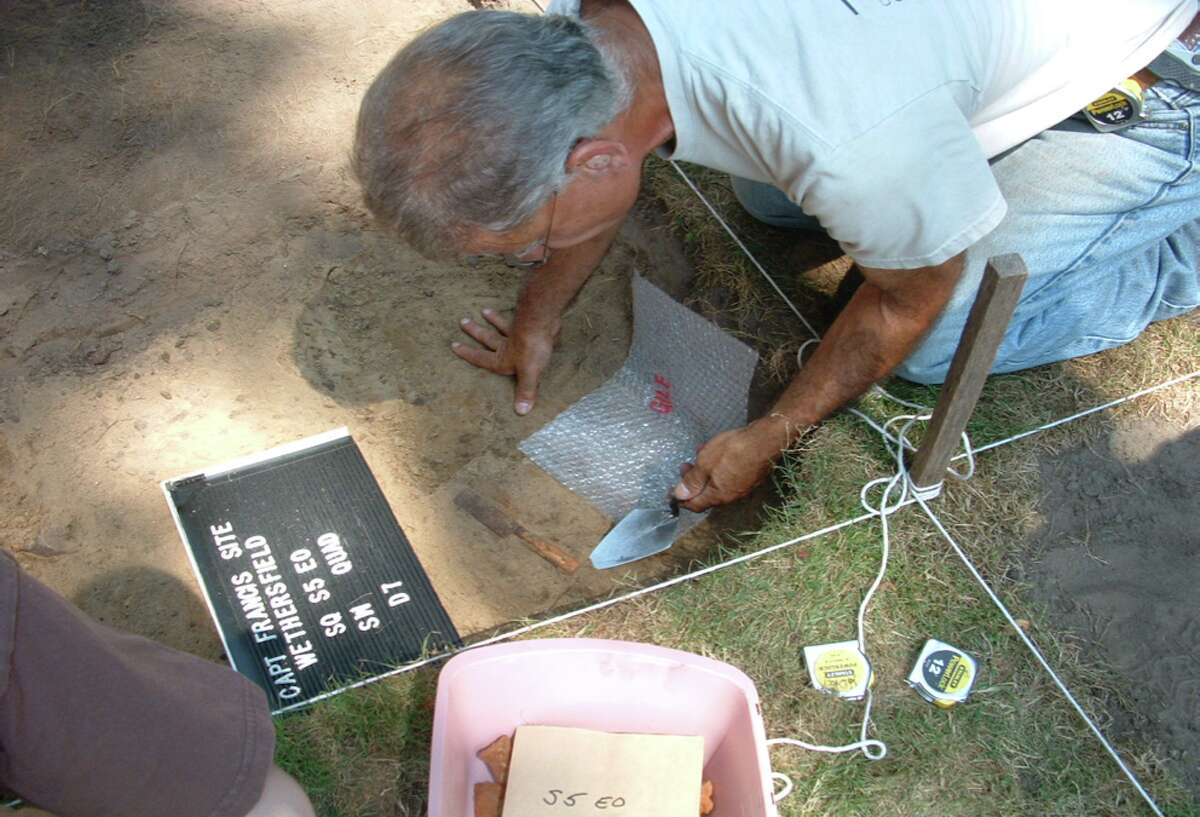 Former state archeologist Nick Bellantoni excavating at an archeological site. 