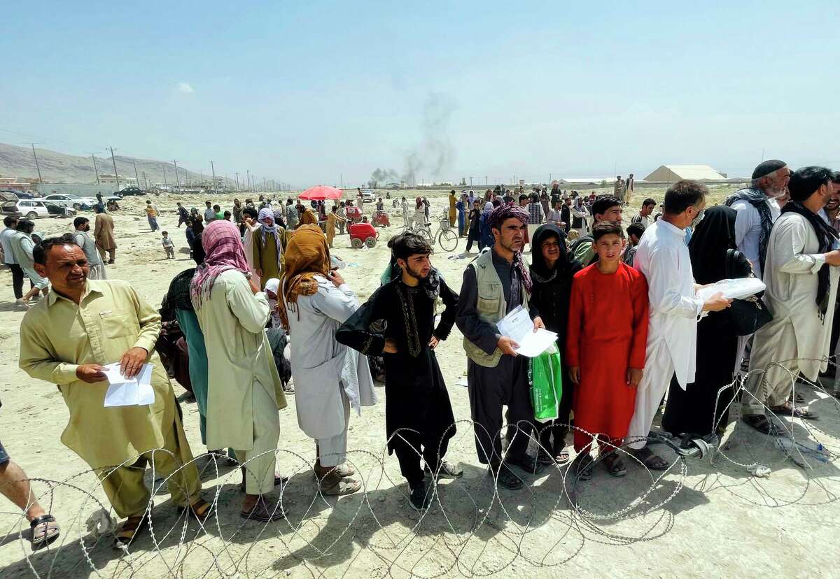 Hundreds of people gather outside the airport in Kabul, Afghanistan, seeking to flee the Taliban. A reader pins this failure clearly on President Joe Biden.