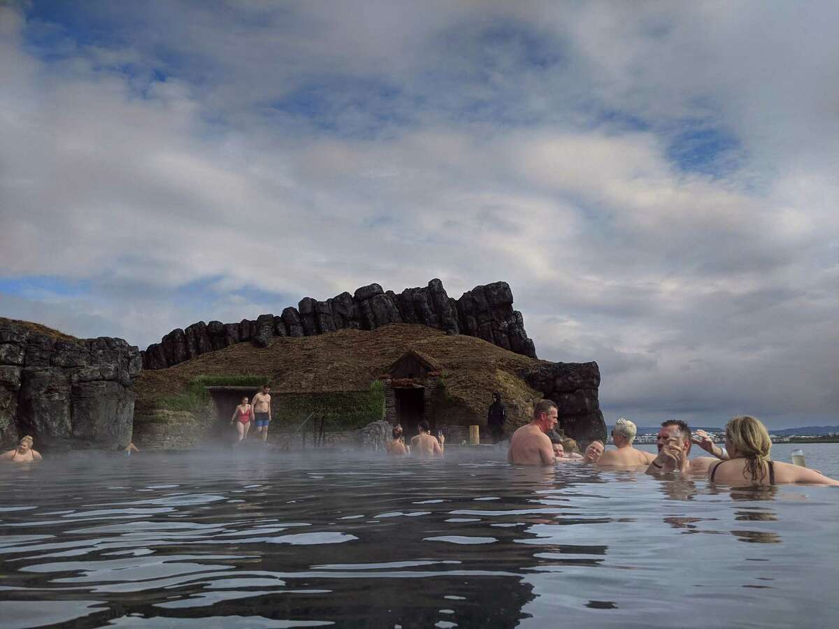 Bathers in the new Sky Lagoon outside of Reykjavik. Spa buildings are topped with turf, long a traditional building material in a country where trees are scarce.