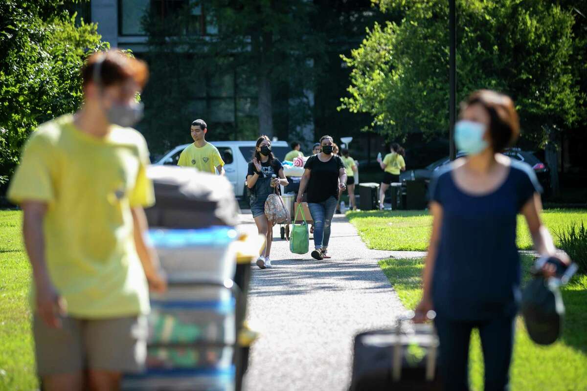 Students and their familes carry their belongings into dorms during move-in at Rice University Sunday, Aug. 15, 2021.