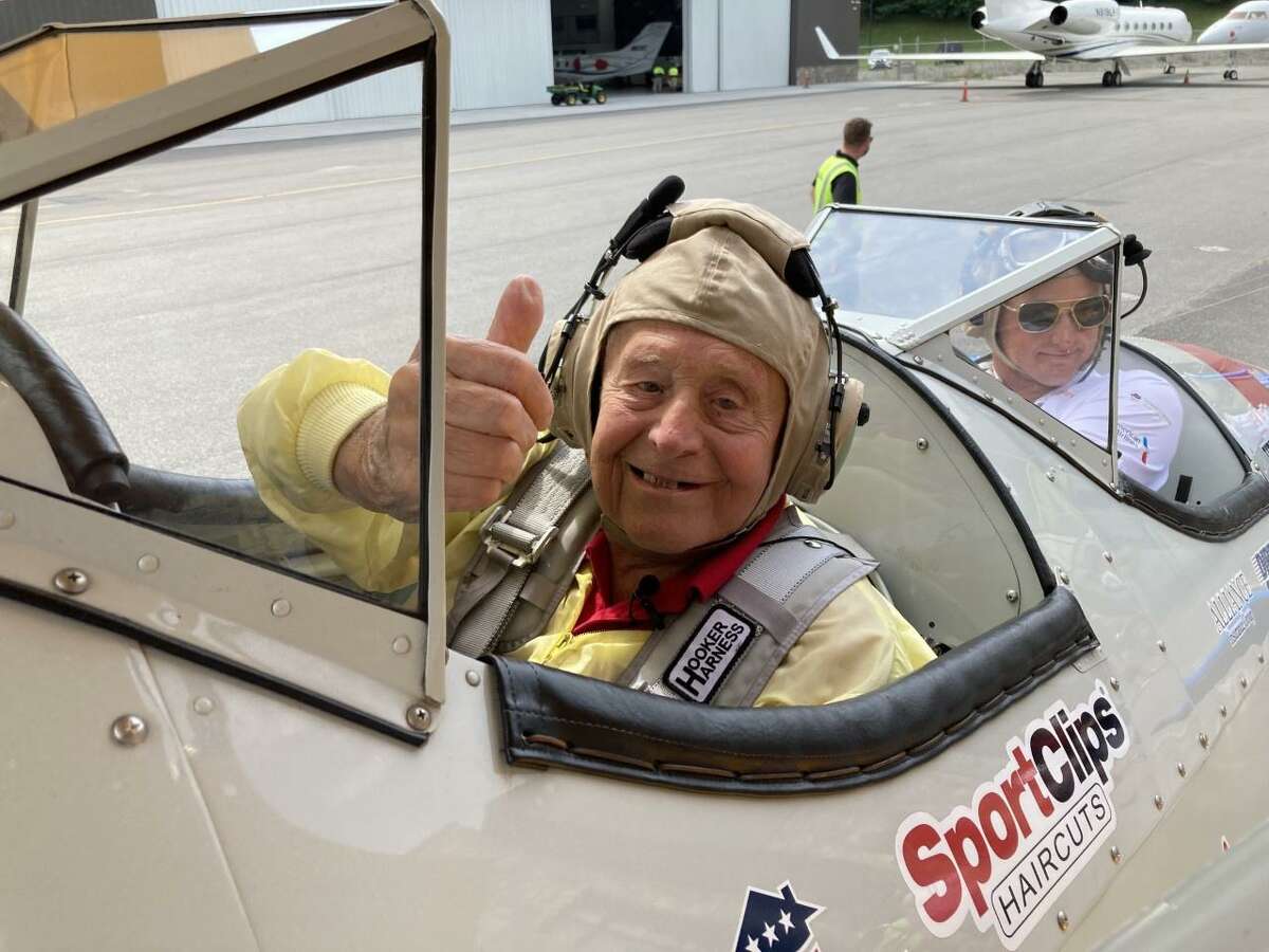 Darien resident Robert Mitchell, 95, in a restored vintage Boeing Stearman biplane at Westchester County Airport.