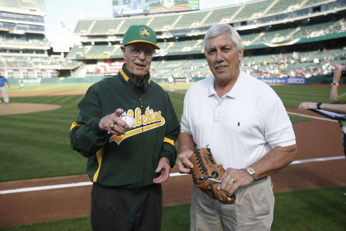 OAKLAND, CA - JULY 2: Monte Moore stands on the field with Broadcaster Ray Fosse of the Oakland Athletics prior to the game between the Athletics and the Minnesota Twins at the Oakland-Alameda County Coliseum on July 2, 2019 in Oakland, California. The Athletics defeated the Twins 8-6. (Photo by Michael Zagaris/Oakland Athletics/Getty Images)
