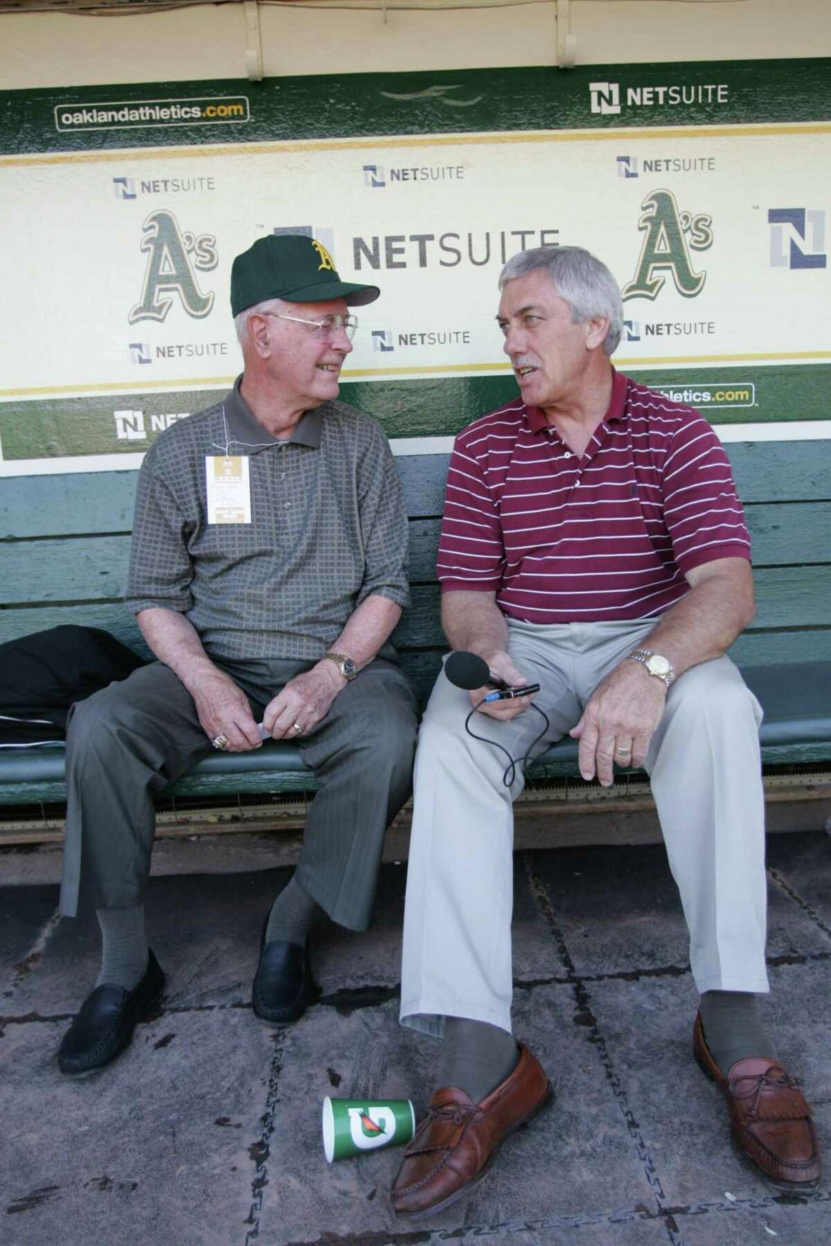 OAKLAND, CA - JUNE 23: Monte Moore and Ray Fosse in the dugout prior to the Oakland Athletics game against the San Francisco Giants at the Oakland Coliseum on June 23, 2009 in Oakland, California. The Giants defeated the Athletics 4-1. (Photo by Michael Zagaris/Getty Images)