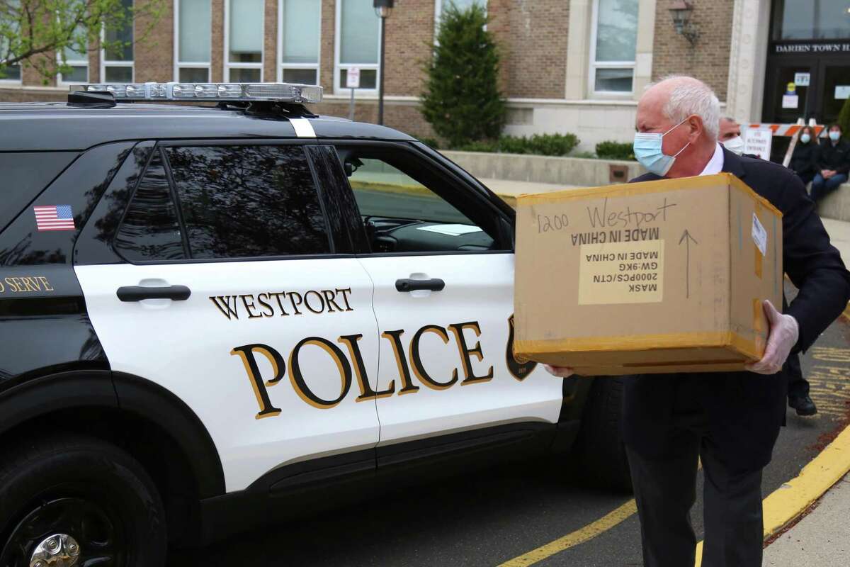 Westport First Selectman Jim Marpe picks up a donation of masks for Westport first responders on in April 2020 at Darien’s town hall.