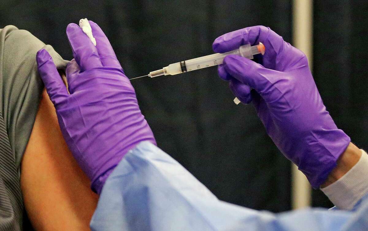 A man gets a COVID-19 vaccine.