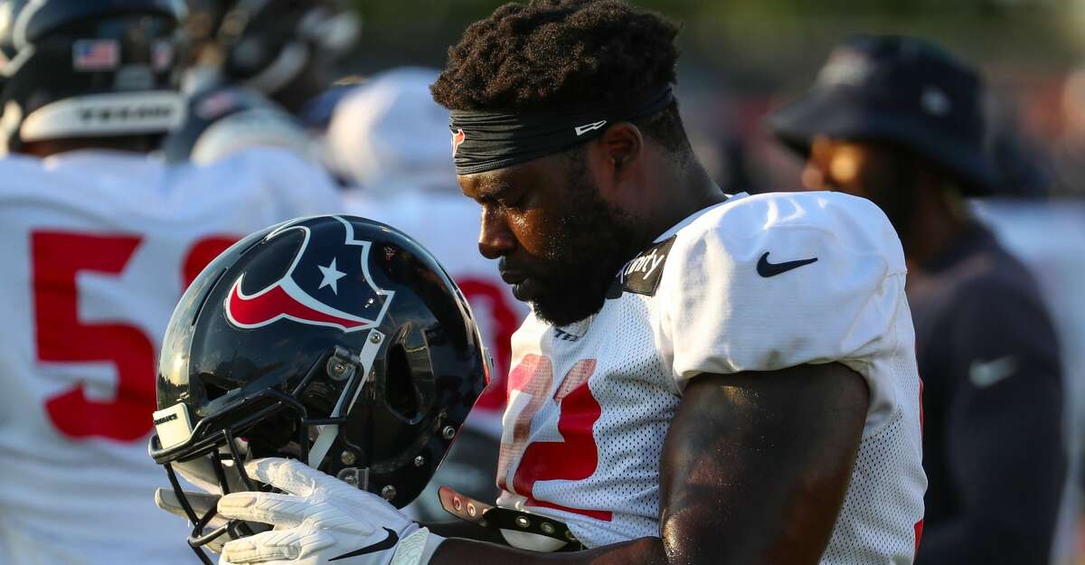 Houston Texans nose tackle Brandon Dunn (92) dons his helmet during an NFL training camp football practice Saturday, Aug. 7, 2021, in Houston.
