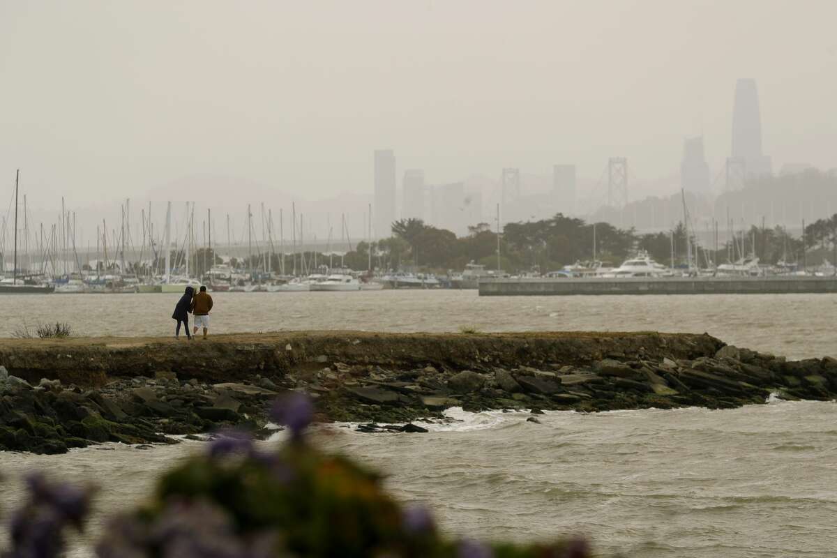 Wildfire smoke hangs over the Emeryville Marina and the San Francisco skyline in this view from West Frontage Road in Emeryville, Calif., on Wednesday, Aug. 18, 2021.