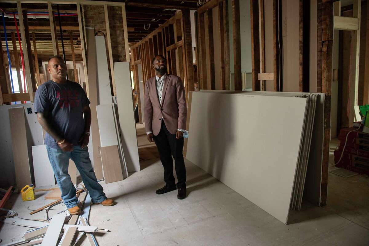 Deepnarayan Jealall, first-time homebuyer, left, shows Maurice A. Brown III, city of Schenectady's home ownership coordinator, the home he is renovating on Thursday, Aug. 19, 2021 in Schenectady, N.Y.