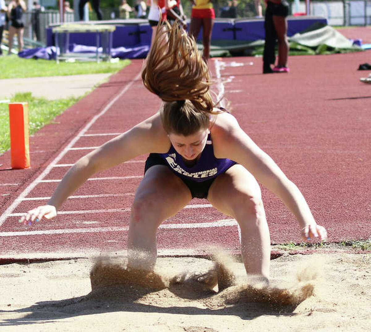 CM grad Jackie Woelfel, shown during long jump competition for the Eagles track team, signed with Kansas Jayhawks rowing earlier this year and will begin fall workouts, along with classes, Monday in Lawrence.