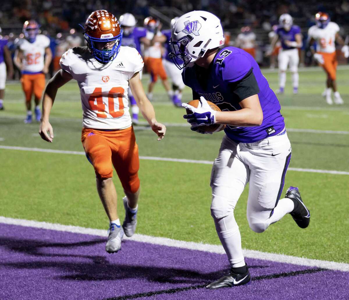 Willis halfback Kory Ford (13) scores a touchdown despite pressure from Grand Oaks linebacker Brayden Bradley (40) during the second quarter of a District 13-6A football game at Berton A. Yates Stadium in Willis on Friday, Nov. 20, 2020.