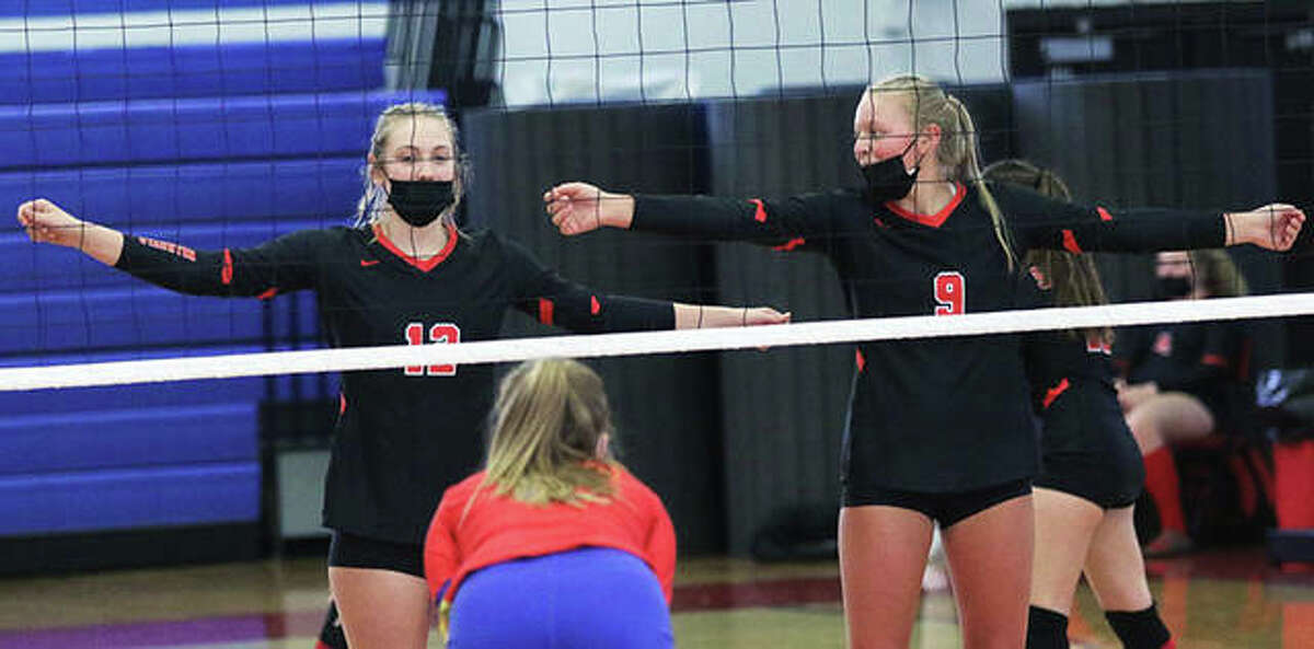 Staunton’s Haris Legendre (left) and Danielle Russell (9) wait for serve during a SCC volleyball match at Roxana last season. The Bulldogs, expecting another big season after going 14-2 and winning the SCC, are on hold for the 2021 season with Staunton sports temporarily shut down because of COVID-19 concerns.