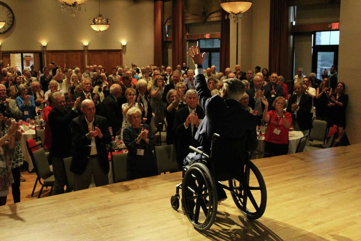 An unmasked Gov. Greg Abbott waves to an unmasked crowd during a Republican event in Collin County on Monday night. How many people did the governor infect with COVID?