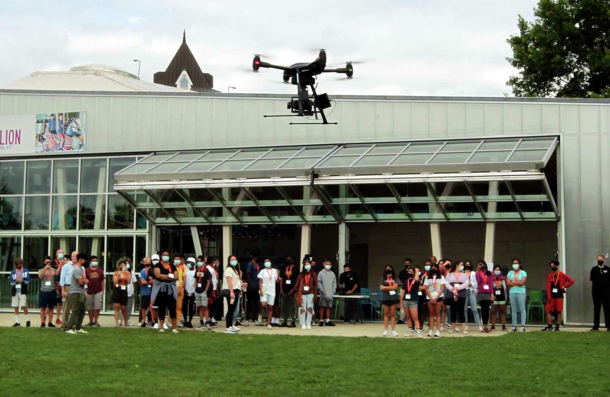 A group of 50 incoming high school freshman in Stamford High School, who've started working towards a technology-focused college degree through the Beyond Limits Summer Scholars Program, attend an unmanned aerial vehicle (UAV) flight demonstration by Aquiline Drones at Mill River Park in Stamford, Conn., on Thursday August 19, 2021. This is the fifth year of the week-long summer program, which is organized and managed by Beyond Limits, a division of the Stamford Peace Youth Foundation, Inc.