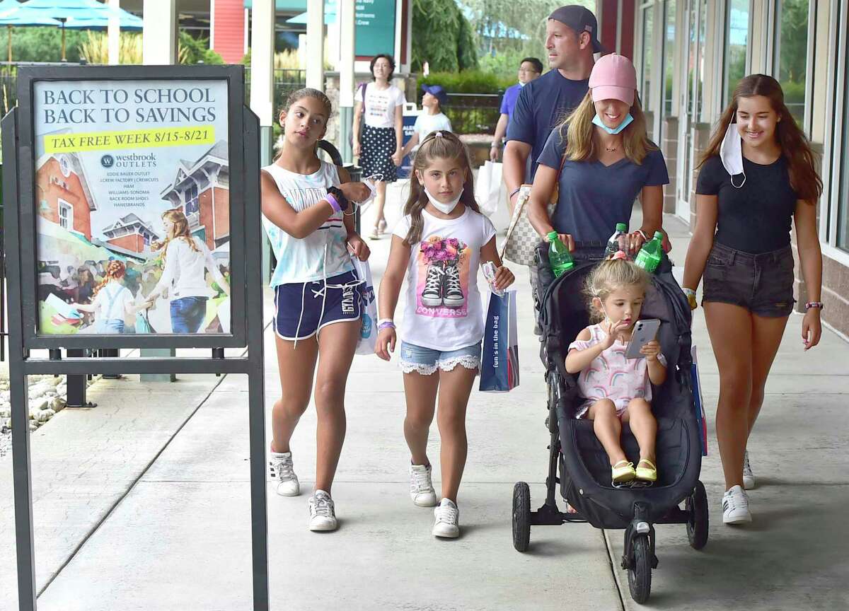 Marc and Karen Mirabella of White Plains, N.Y., on vacation in Connecticut, take advantage of the shopping at the Westbrook Outlets Aug. 19, 2021. The children, from left: Emily, 11, Alexa, 9, Nadia, 3, and Julia, 4.