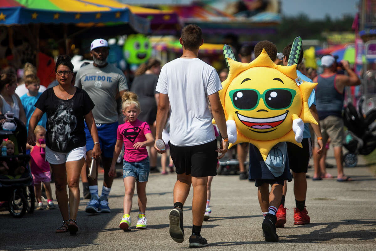 Fairgoers enjoy rides and games at the Midland County Fair carnival Friday, Aug. 20, 2021. (Katy Kildee/kkildee@mdn.net)