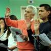 Albino Marinho, 64, center, an immigrant from Portugal, Francisco Gonzalez, 25, and Guadalupe, 50, immigrants from Miexico take the oath of citizenship Wednesday. A naturalization ceremony is held at the Danbury Library Wednesday, April 11, 2018. The share of the Hispanic and Latino population in Danbury grew by 8.2 percentage points over 10 years, one of the largest increases in the state.