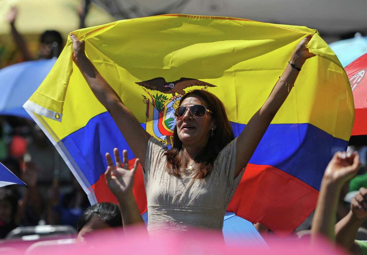 A festival-goer sports a flag of Ecuador at the Ecuadorian Festival at Ives Concert Park in Danbury, Conn. on Sunday, Aug. 11, 2013. The share of the Hispanic and Latino population in Danbury grew by 8.2 percentage points over 10 years, one of the largest increases in the state.