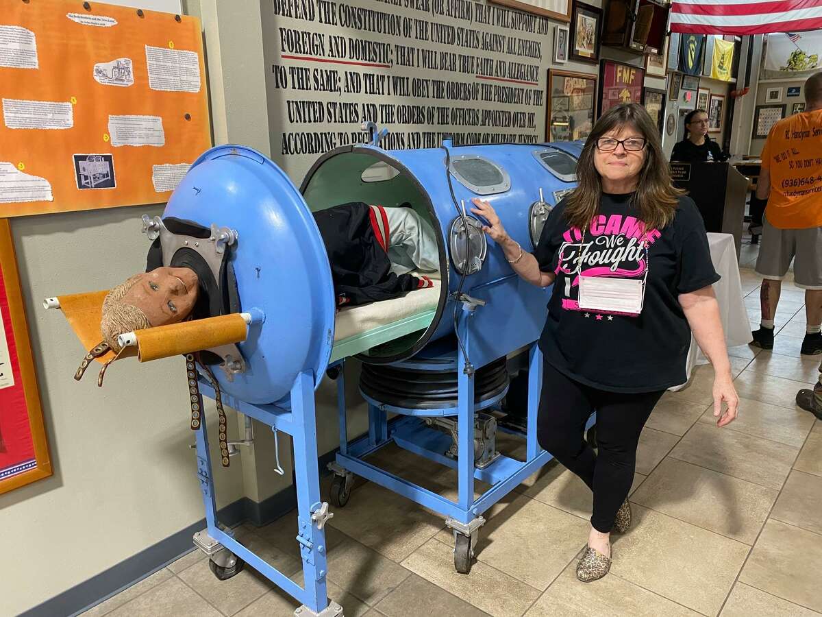 Rotary Club of Conroe member Kris Nordstrom McBride is pictured with an iron lung borrowed from one of the East Texas Rotary clubs for the Conroe club's In Spirits of Spirits of Texas in October 2020. Eradicating polio is one of Rotary’s causes and iron lungs were used to treat polio patient. This year's event is set for the evening of Oct. 26 at Honor Cafe.