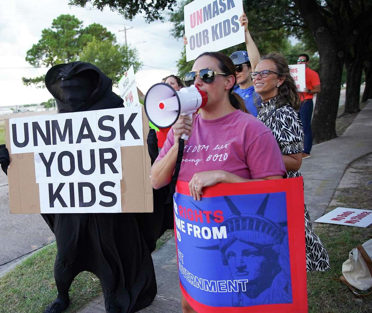 Anti-mask demonstrators outside Houston Independent School District building before it holds a meeting about having a mask mandate in Houston on Thursday, Aug. 12, 2021.