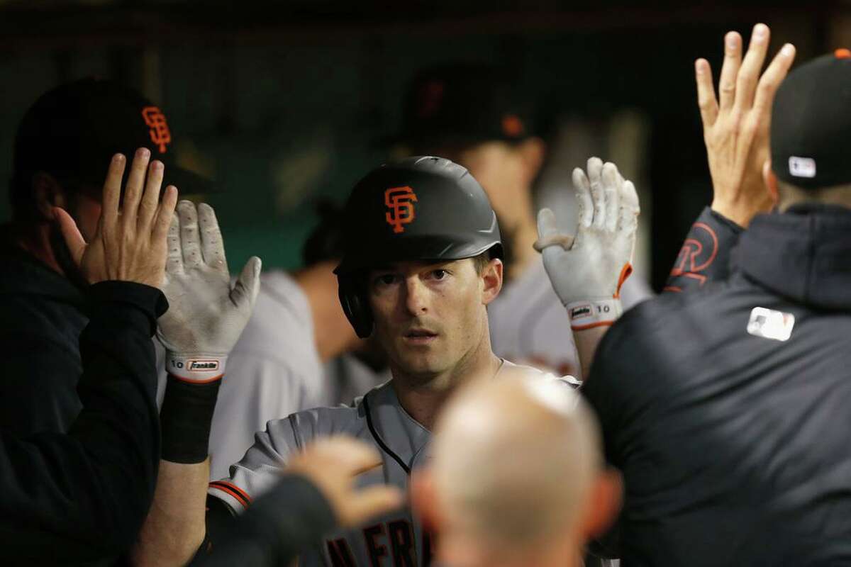 OAKLAND, CALIFORNIA - AUGUST 20: Mike Yastrzemski #5 of the San Francisco Giants celebrates in the dugout after hitting a solo home run in the top of the fifth inning against the Oakland Athletics at RingCentral Coliseum on August 20, 2021 in Oakland, California. (Photo by Lachlan Cunningham/Getty Images)