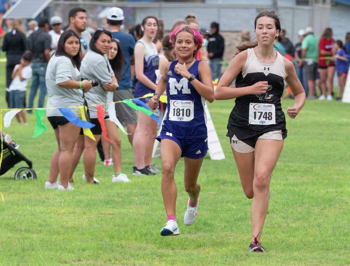 Division 1 girls Charlize Anaya, Midland High and Madeline Layton, Lubbock High race toward the finish 08/21/2021 around Hogan Park and Sibley Nature Center for the Tall City Invitational cross-country meet. Tim Fischer/Reporter-Telegram