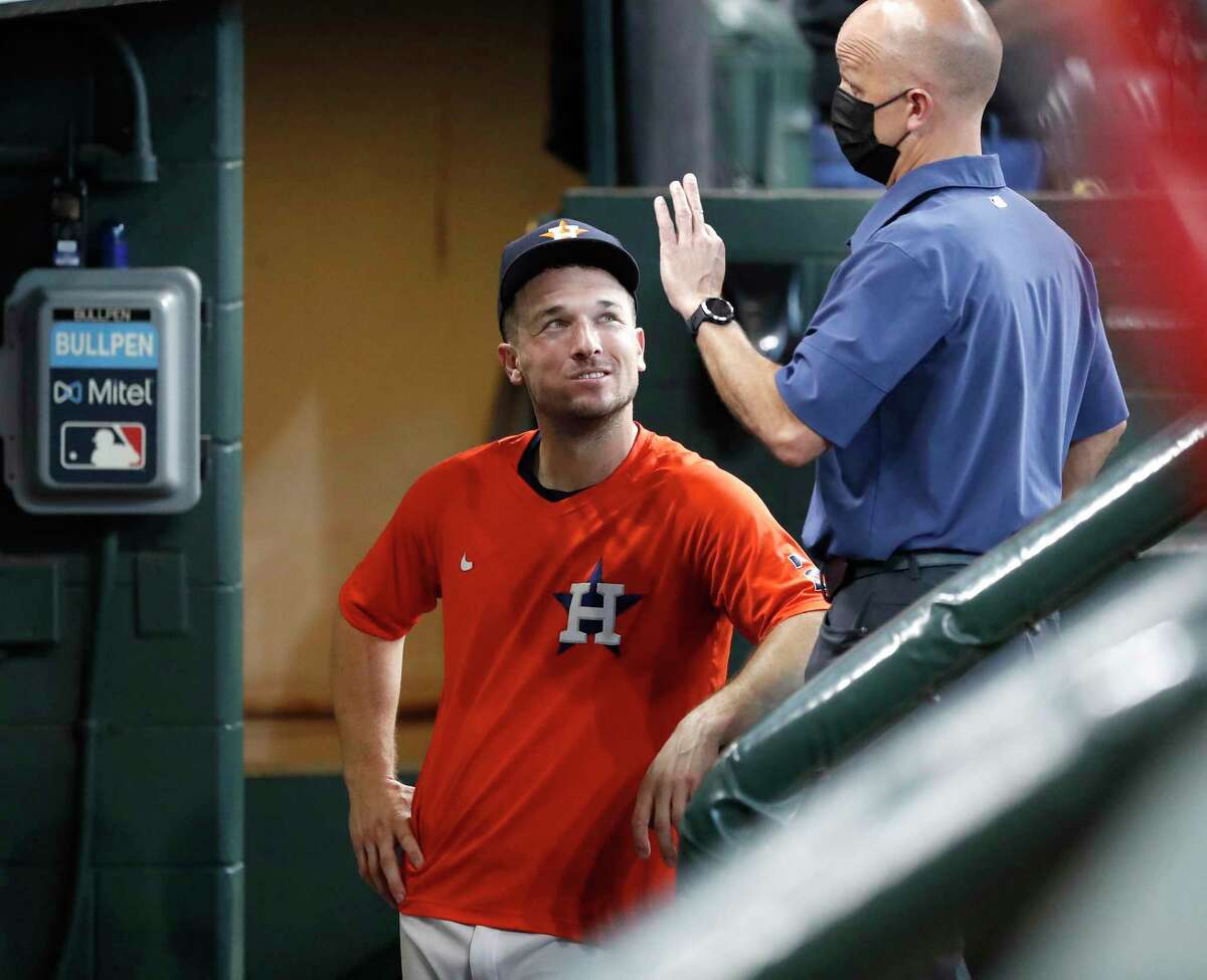 Houston Astros Alex Bregman, who has been rehabbing recently at the Sugar Land Skeeters visits clubhouse manager Carl Schneider in the dugout during batting practice before the start of an MLB baseball game at Minute Maid Park, Saturday, August 21, 2021, in Houston.