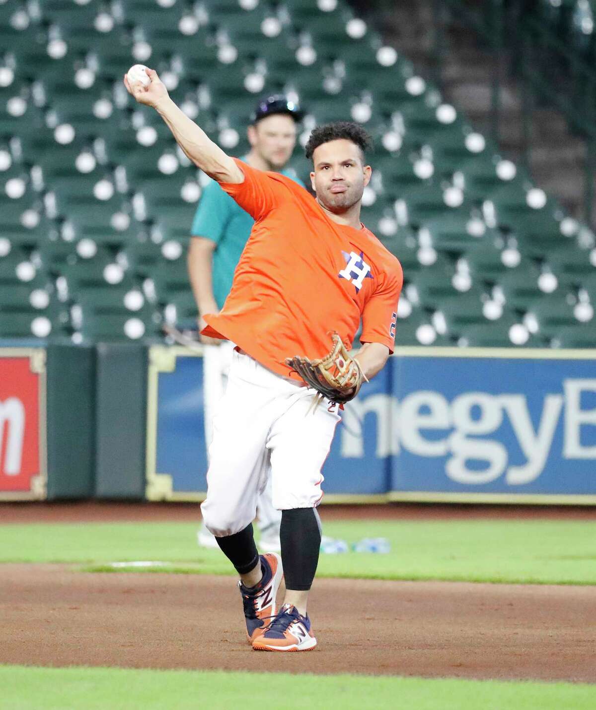Houston Astros second baseman Jose Altuve (27) throws from third base during infield drills before the start of an MLB baseball game at Minute Maid Park, Saturday, August 21, 2021, in Houston.