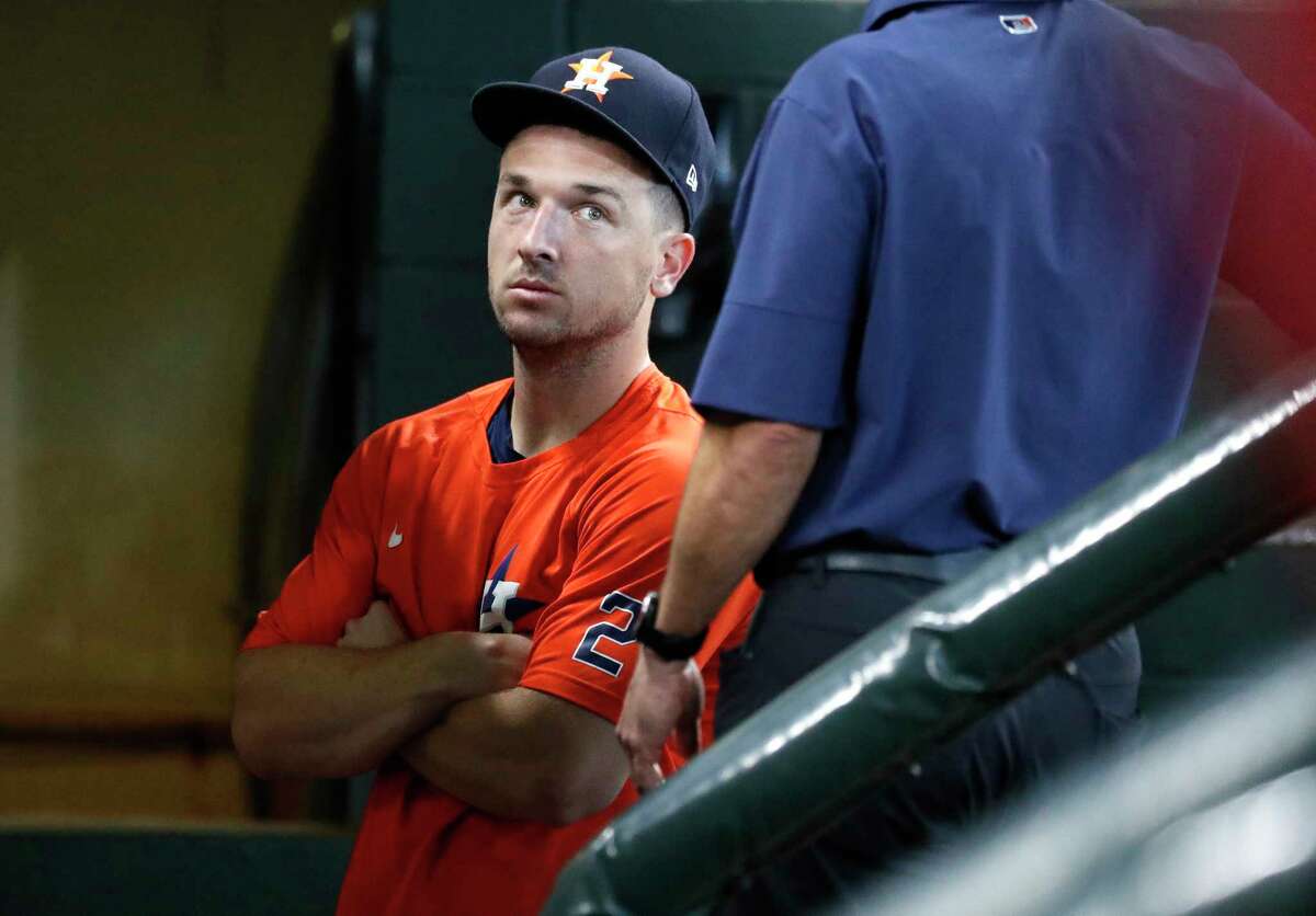 Houston Astros Alex Bregman, who has been rehabbing recently at the Sugar Land Skeeters visits the dugout during batting practice before the start of an MLB baseball game at Minute Maid Park, Saturday, August 21, 2021, in Houston.