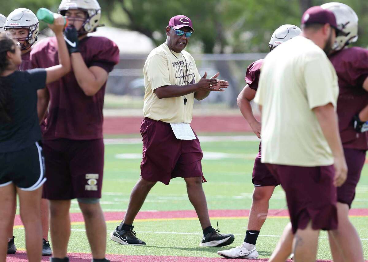 Sports profile on Cotulla football coach Marcus Booker. He was overseeing an after school practice on Tuesday, Aug. 17, 2021. Booker emerged from retirement to coach the team he led to the state semifinals in 2006. Booker felt a calling to return to coaching after his wife, Josie, died of COVID-19 last year. Booker, who played for the legendary D.W. Rutledge at Judson, also served as the head coach at South San from 2012-14.