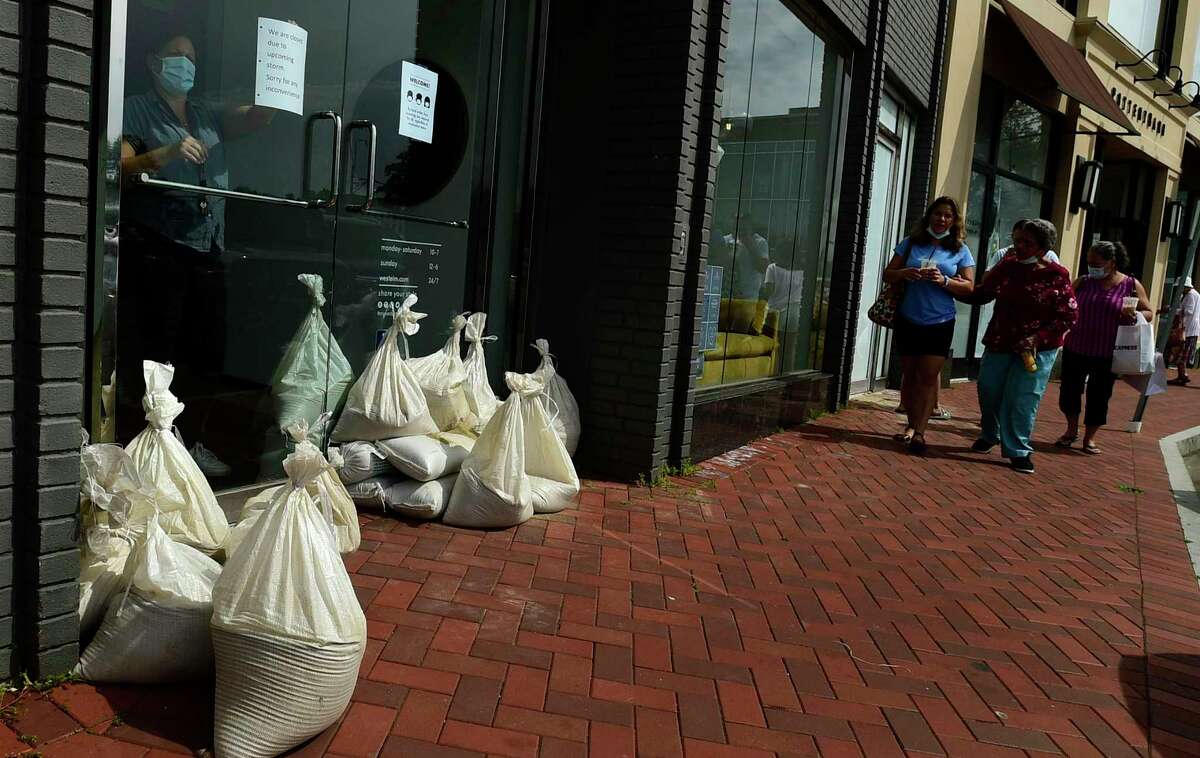 Employees at West Elm close early to prepare for flooding ahead of Hurricane Henri Saturday August 21, 2021, in Westport, Conn.