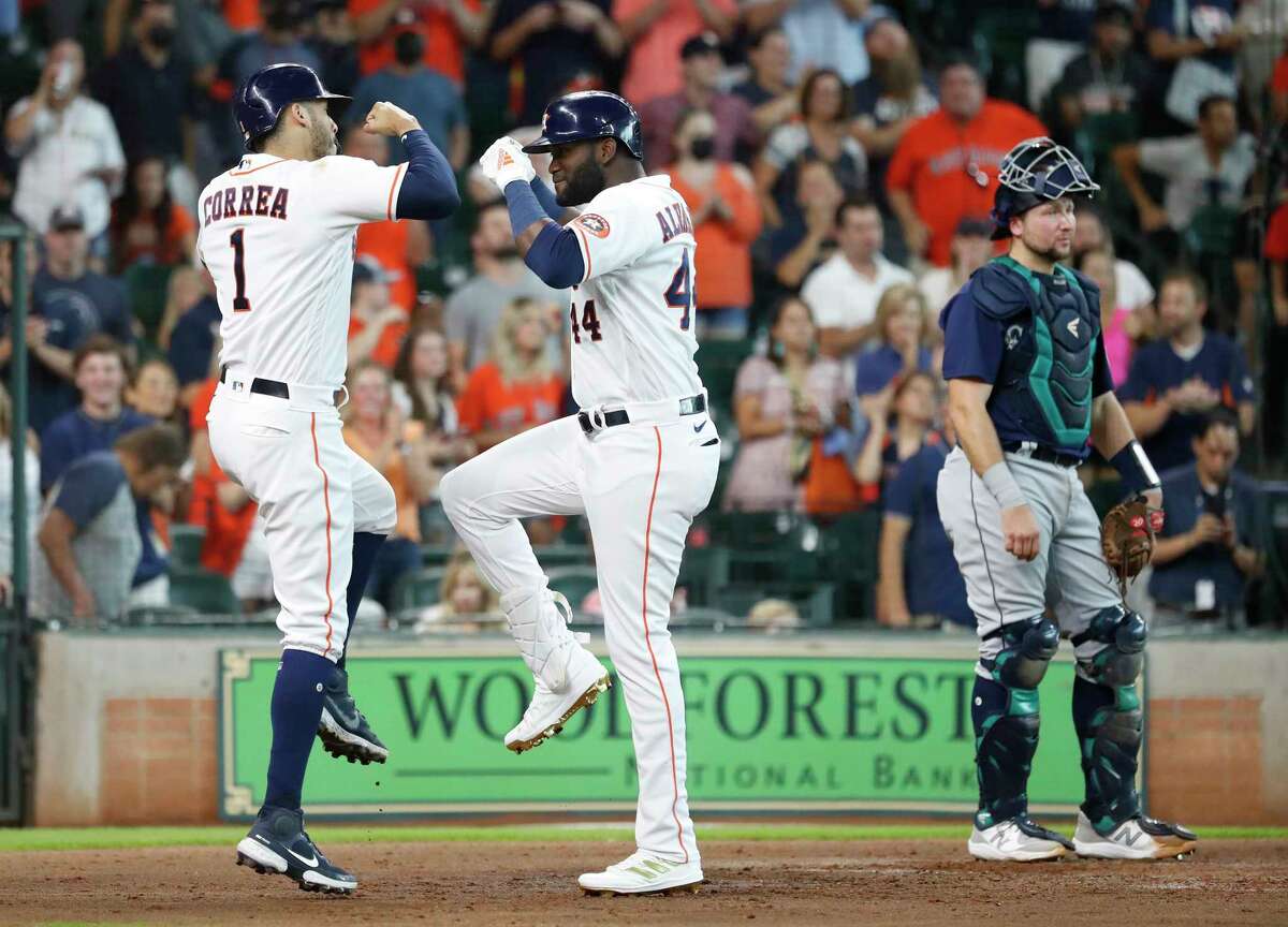 Houston Astros Yordan Alvarez celebrates his three-run home run off Seattle Mariners starting pitcher Logan Gilbert with Carlos Correa during the third inning of an MLB baseball game at Minute Maid Park, Saturday, August 21, 2021, in Houston.