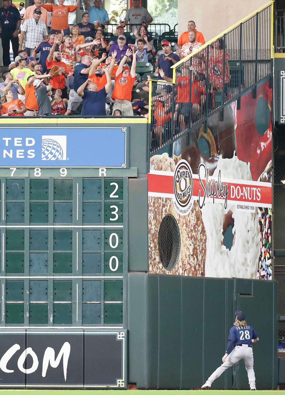 Fans in the Crawford Boxes reach for Houston Astros Yordan Alvarez's three-run home run off Seattle Mariners starting pitcher Logan Gilbert during the third inning of an MLB baseball game at Minute Maid Park, Saturday, August 21, 2021, in Houston.