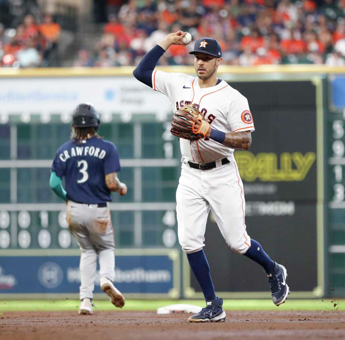 Houston Astros shortstop Carlos Correa (1) makes the throw to first base as Seattle Mariners Kyle Seager ground out during the third inning of an MLB baseball game at Minute Maid Park, Saturday, August 21, 2021, in Houston.