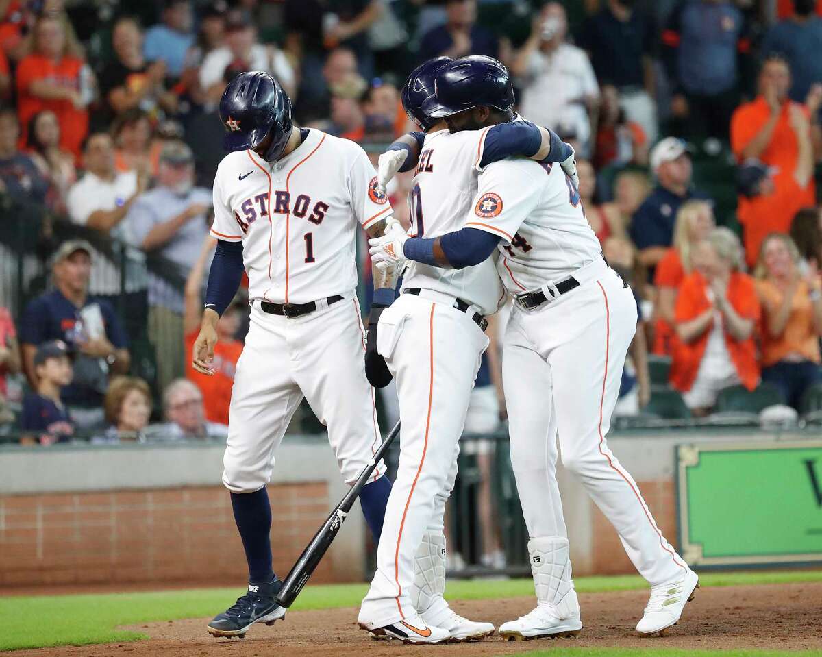 Houston Astros Yordan Alvarez celebrates his three-run home run off Seattle Mariners starting pitcher Logan Gilbert with Yuli Gurriel (10) during the third inning of an MLB baseball game at Minute Maid Park, Saturday, August 21, 2021, in Houston.