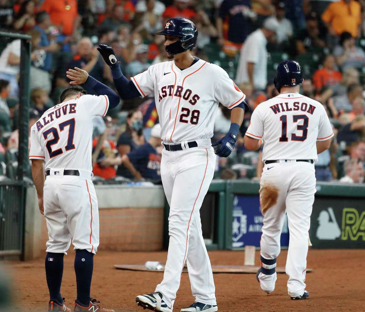 Houston Astros Taylor Jones (28) celebrates his home run off of Seattle Mariners starting pitcher Logan Gilbert with Jose Altuve (27) during the fourth inning of an MLB baseball game at Minute Maid Park, Saturday, August 21, 2021, in Houston.