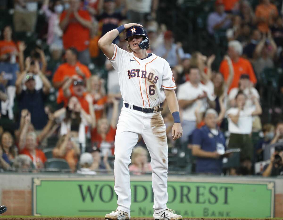 Houston Astros Jake Meyers (6) scores a run against Seattle Mariners catcher Cal Raleigh on Houston Astros Jacob Wilson's RBI double during the fifth inning of an MLB baseball game at Minute Maid Park, Saturday, August 21, 2021, in Houston.
