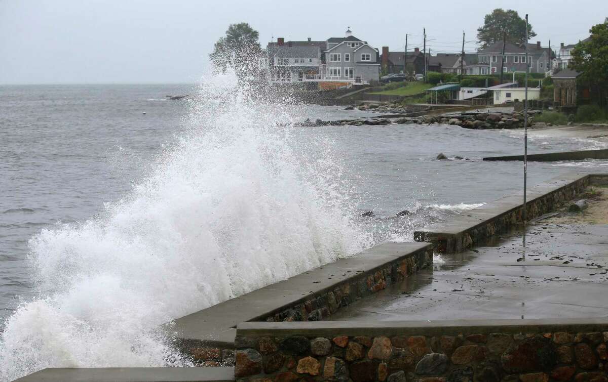 Waves crash against the sea wall along Pequot Avenue in New London, Conn. as Tropical Storm Henri approaches Sunday, Aug. 22, 2021.