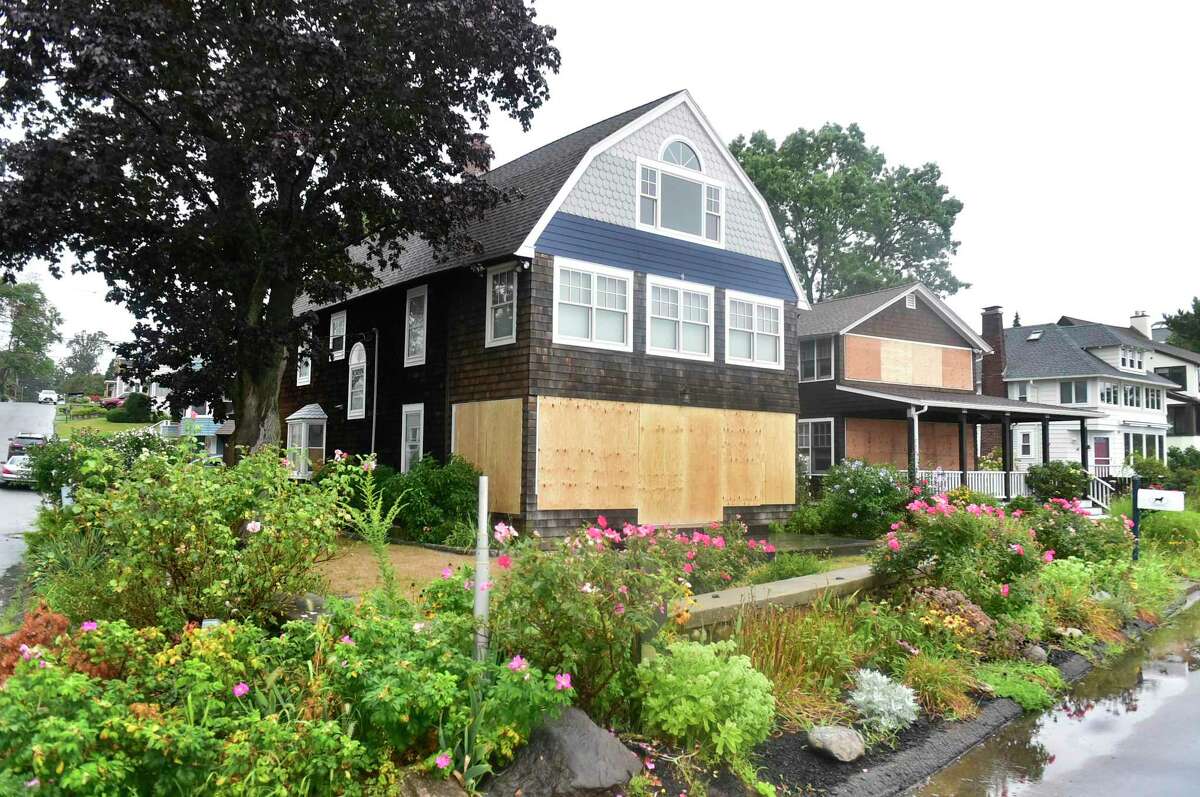 Boarded up houses prepped for Tropical Storm Henri early Sunday morning facing Long Island sound in Branford between First and Second avenues next to the Hotchkiss Grove Association Beach.